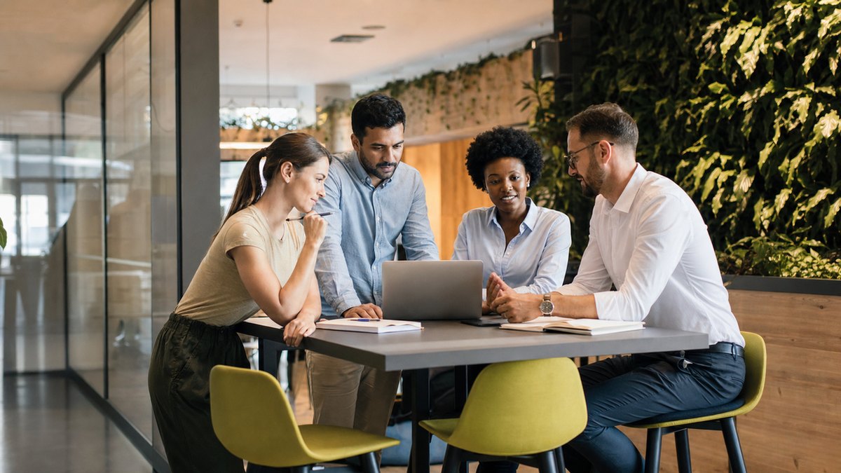 Office collaboration scene with a small strategy team